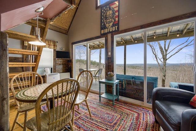 sunroom featuring vaulted ceiling