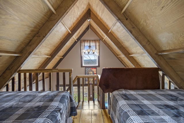 unfurnished bedroom featuring wooden ceiling, multiple windows, lofted ceiling, and wood-type flooring