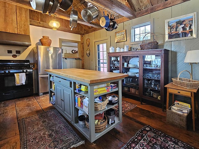 kitchen featuring wood counters, stainless steel fridge, black gas range oven, dark hardwood / wood-style flooring, and wood ceiling