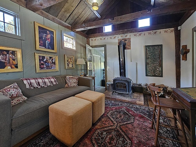 living room featuring lofted ceiling with beams, a wood stove, and wood ceiling