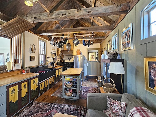 living room with dark wood-type flooring, lofted ceiling with beams, and wooden ceiling