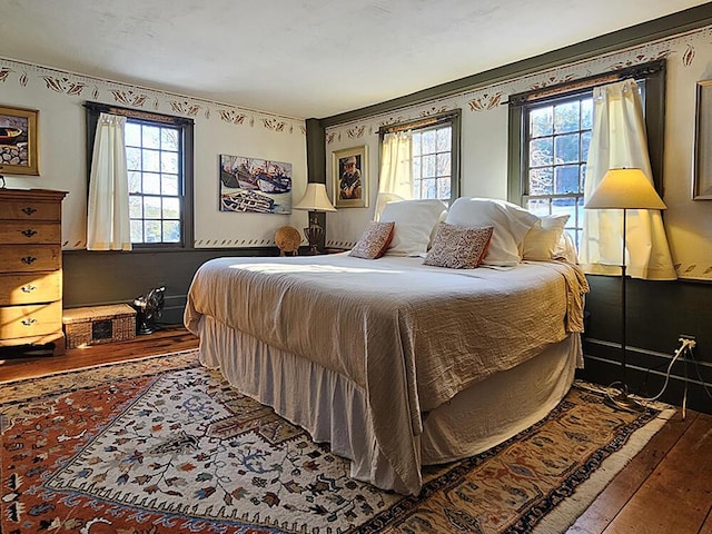 bedroom featuring wood-type flooring and multiple windows