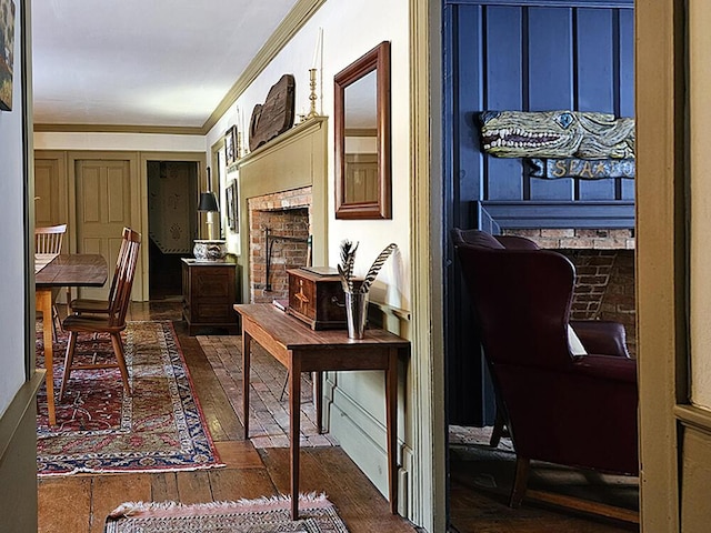 hall with dark wood-type flooring and crown molding