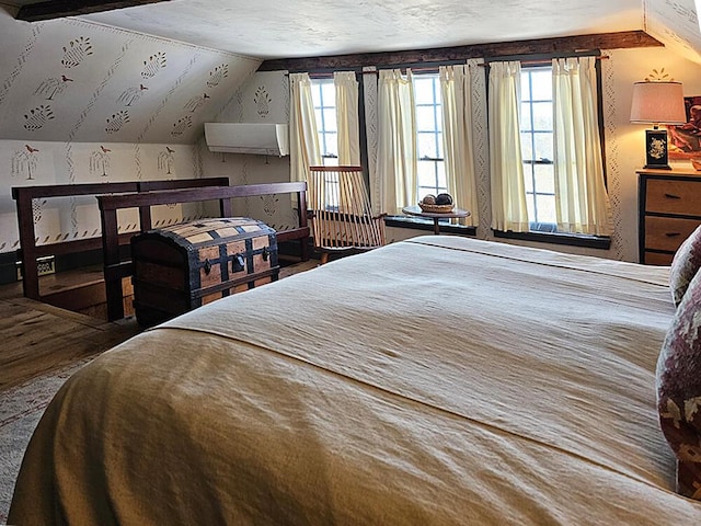 bedroom featuring lofted ceiling and multiple windows