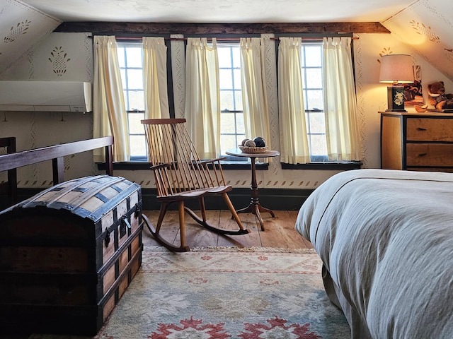 bedroom featuring light hardwood / wood-style floors and lofted ceiling