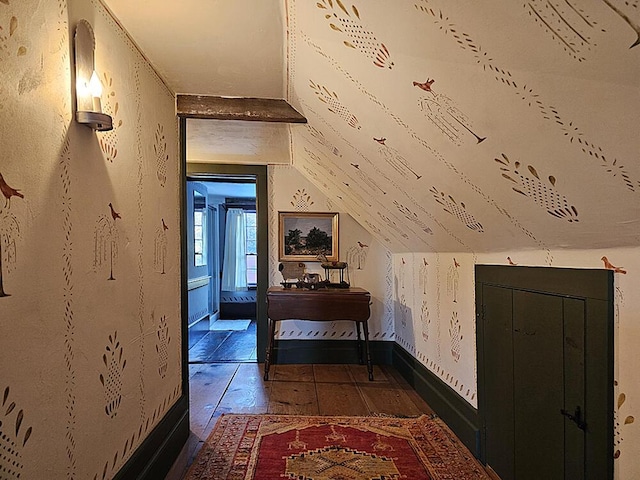 hallway with dark hardwood / wood-style flooring and vaulted ceiling