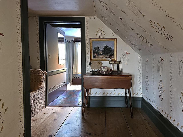 corridor featuring lofted ceiling and hardwood / wood-style floors