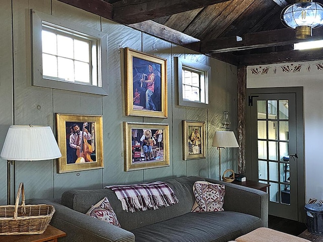 living room with wooden ceiling, lofted ceiling with beams, and a wealth of natural light