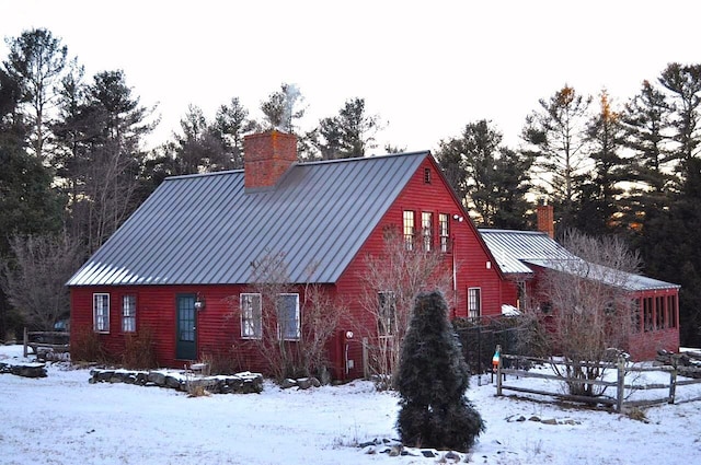 view of snow covered back of property