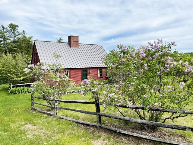 99 Angier Rd, Alna, ME 04535 - view of side of home featuring a chimney, a standing seam roof, and metal roof