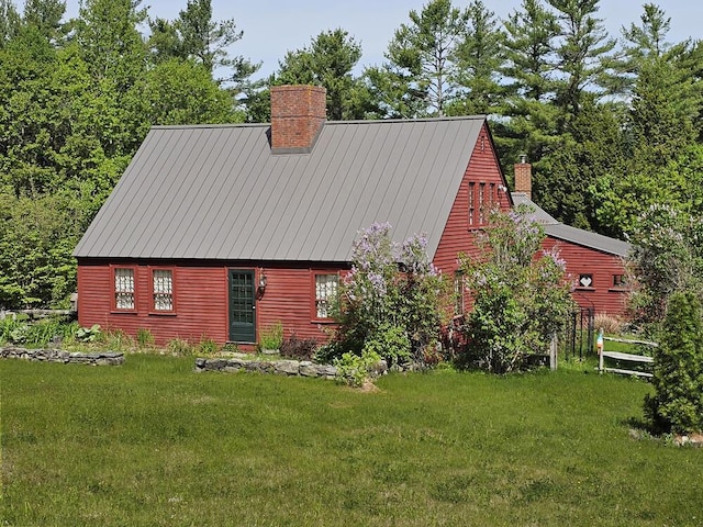 99 Angier Rd, Alna, ME 04535 - view of home's exterior featuring a chimney, a lawn, and a standing seam roof