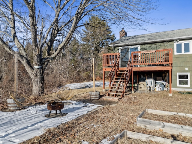 view of yard featuring an outdoor fire pit and a deck