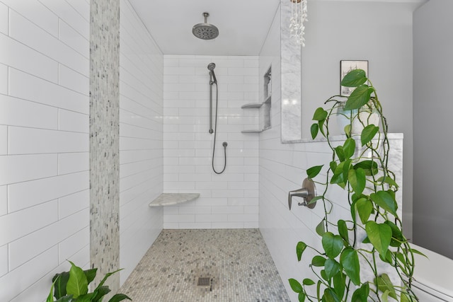 bathroom with toilet and a tile shower