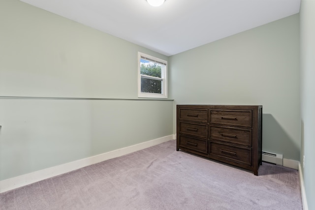 bedroom with light colored carpet and a baseboard heating unit