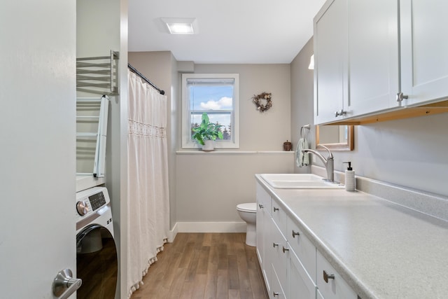 laundry room with washer / dryer, hardwood / wood-style floors, and sink