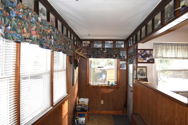 entryway featuring wooden walls and radiator