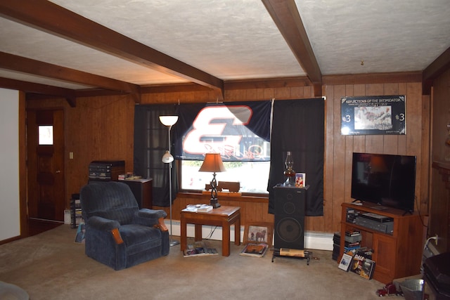 carpeted living room featuring wooden walls, beamed ceiling, and a textured ceiling