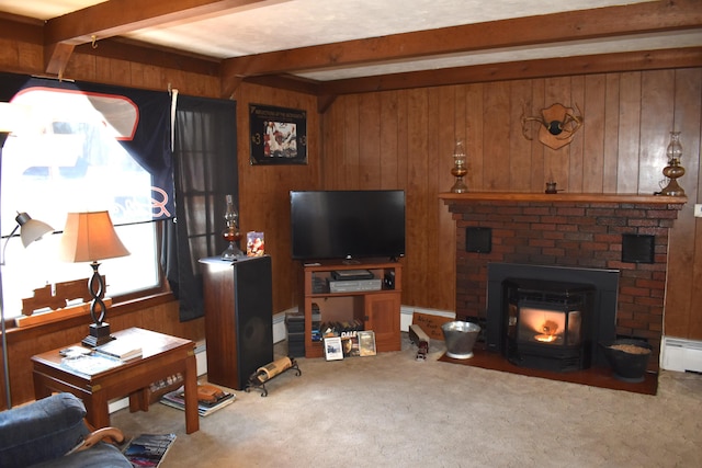 living room with beam ceiling, a wood stove, wooden walls, and carpet