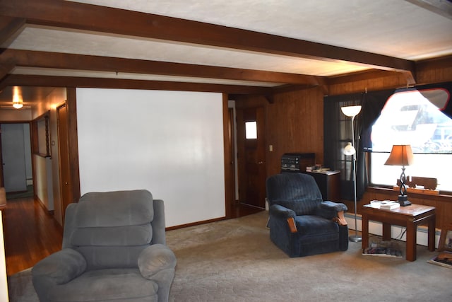 sitting room featuring baseboard heating, carpet floors, and beamed ceiling