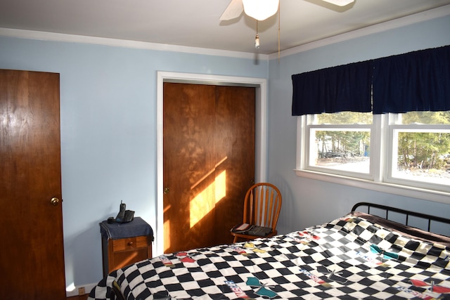 bedroom featuring a closet, ceiling fan, and ornamental molding