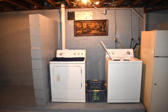 clothes washing area featuring independent washer and dryer