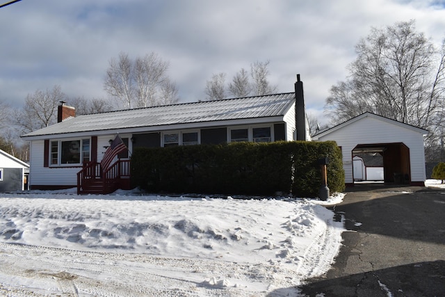 view of front facade featuring an outbuilding and a garage