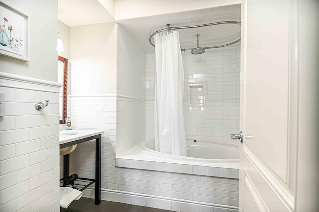 bathroom featuring tile patterned floors, shower / bath combo, and tile walls