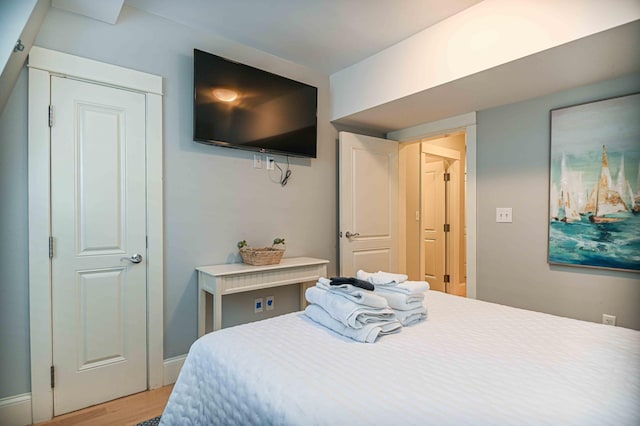 bedroom with hardwood / wood-style flooring