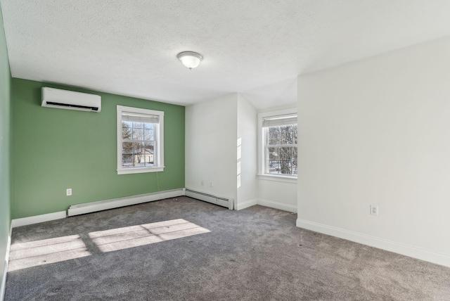 carpeted spare room with a baseboard heating unit, a wall unit AC, and a textured ceiling