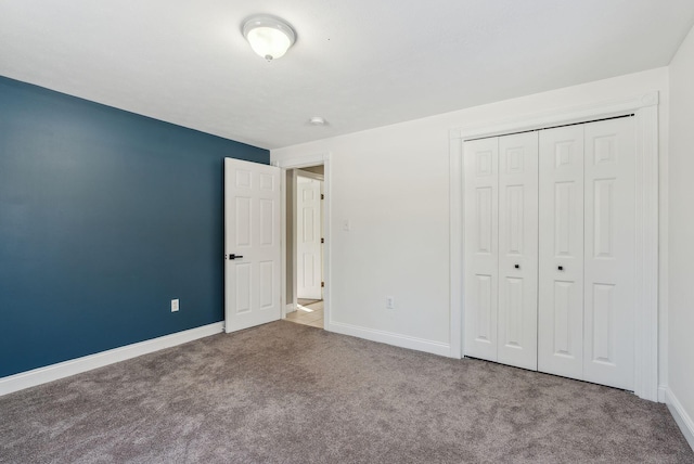 unfurnished bedroom featuring carpet and a closet