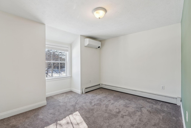 carpeted spare room with a baseboard heating unit, an AC wall unit, and a textured ceiling