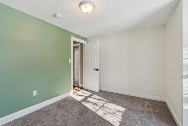 unfurnished room featuring carpet flooring