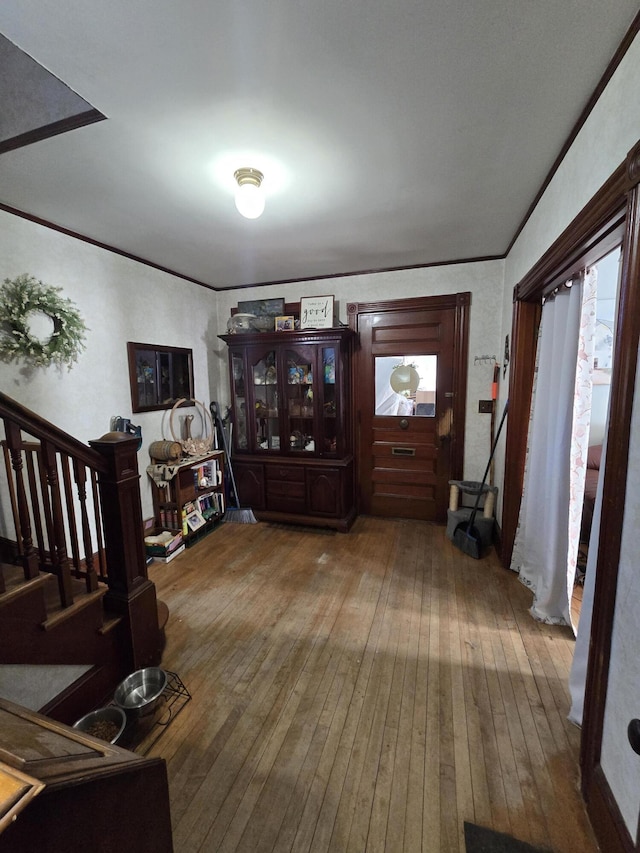 living room with hardwood / wood-style flooring and crown molding