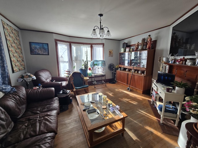 living room with ornamental molding, dark hardwood / wood-style floors, and a notable chandelier