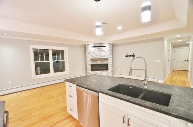 kitchen featuring sink, white cabinets, dishwasher, and hanging light fixtures