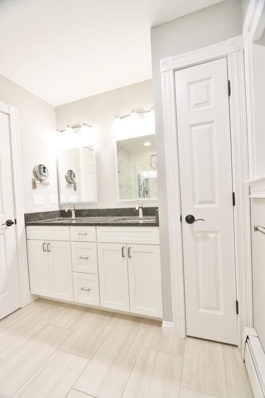 bathroom with baseboard heating and vanity