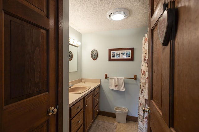 bathroom with vanity and a textured ceiling