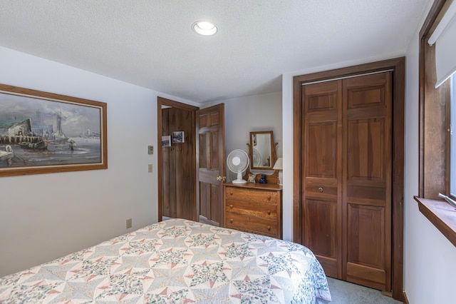 carpeted bedroom featuring a textured ceiling