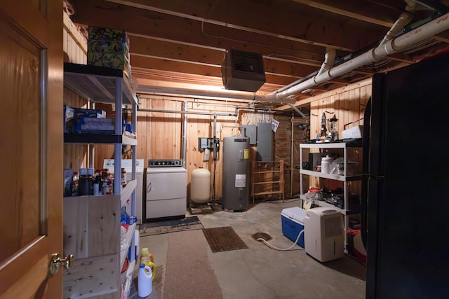 basement with electric panel, water heater, and washer and clothes dryer