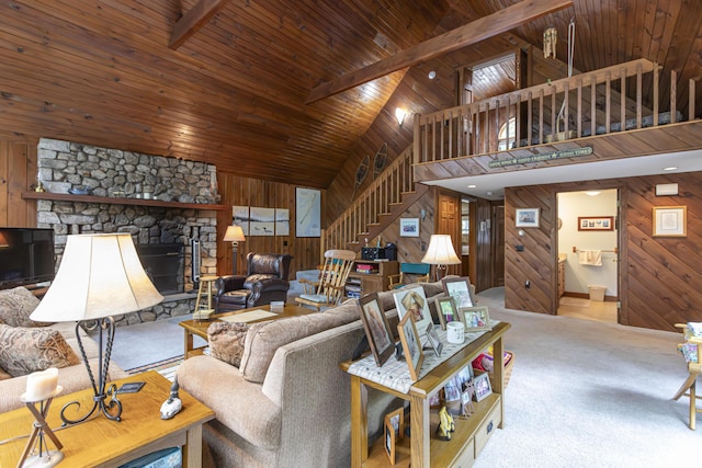 living room featuring beam ceiling, wooden ceiling, a stone fireplace, high vaulted ceiling, and wooden walls