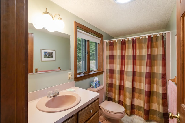 bathroom with a shower with shower curtain, vanity, toilet, and a textured ceiling