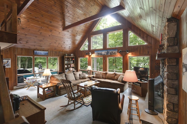 carpeted living room with beamed ceiling, wooden walls, wooden ceiling, and high vaulted ceiling