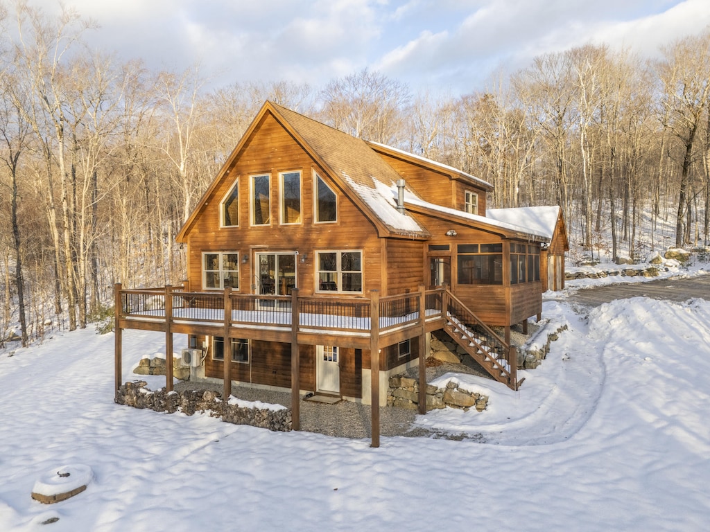 snow covered house with a deck