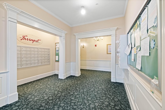 corridor featuring ornamental molding, a mail area, and dark colored carpet