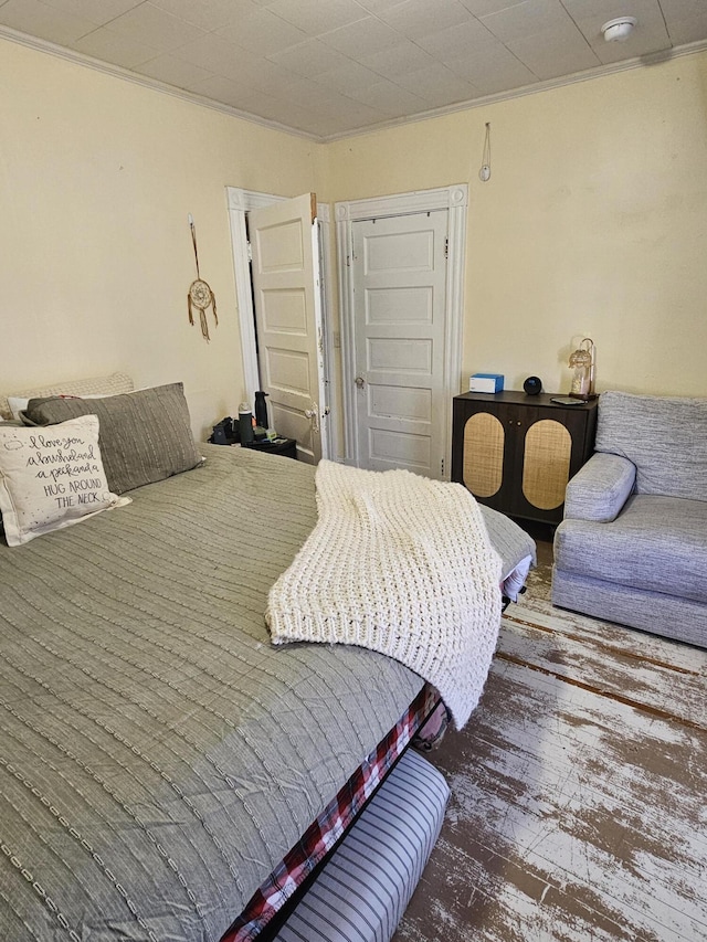 bedroom featuring hardwood / wood-style flooring and crown molding