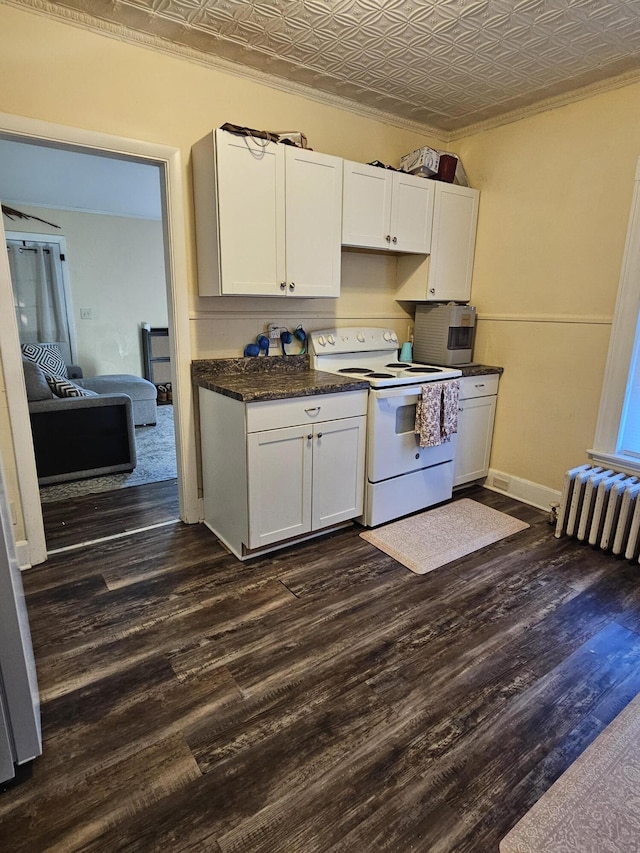 kitchen featuring electric range, dark hardwood / wood-style floors, radiator, and white cabinetry