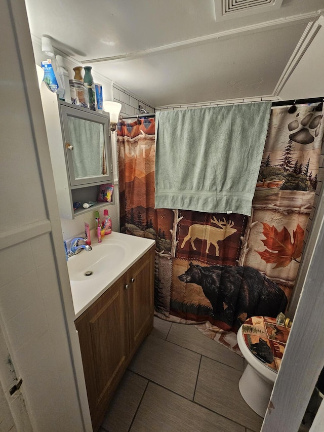 bathroom with vanity, tile patterned floors, and toilet