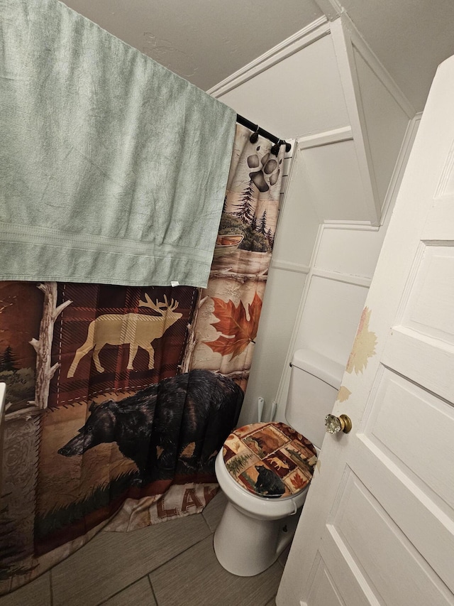 bathroom with toilet and tile patterned flooring