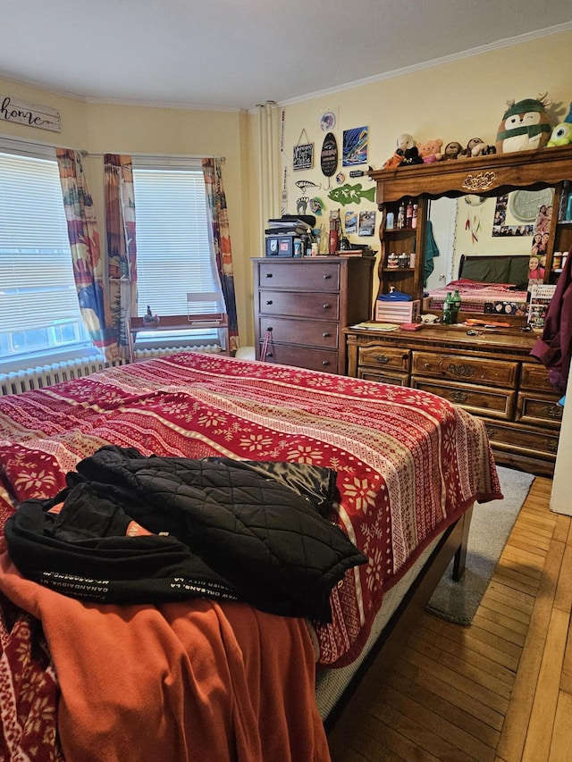 bedroom featuring wood-type flooring and crown molding