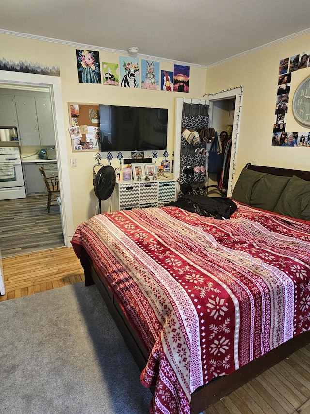 bedroom featuring ornamental molding and hardwood / wood-style floors